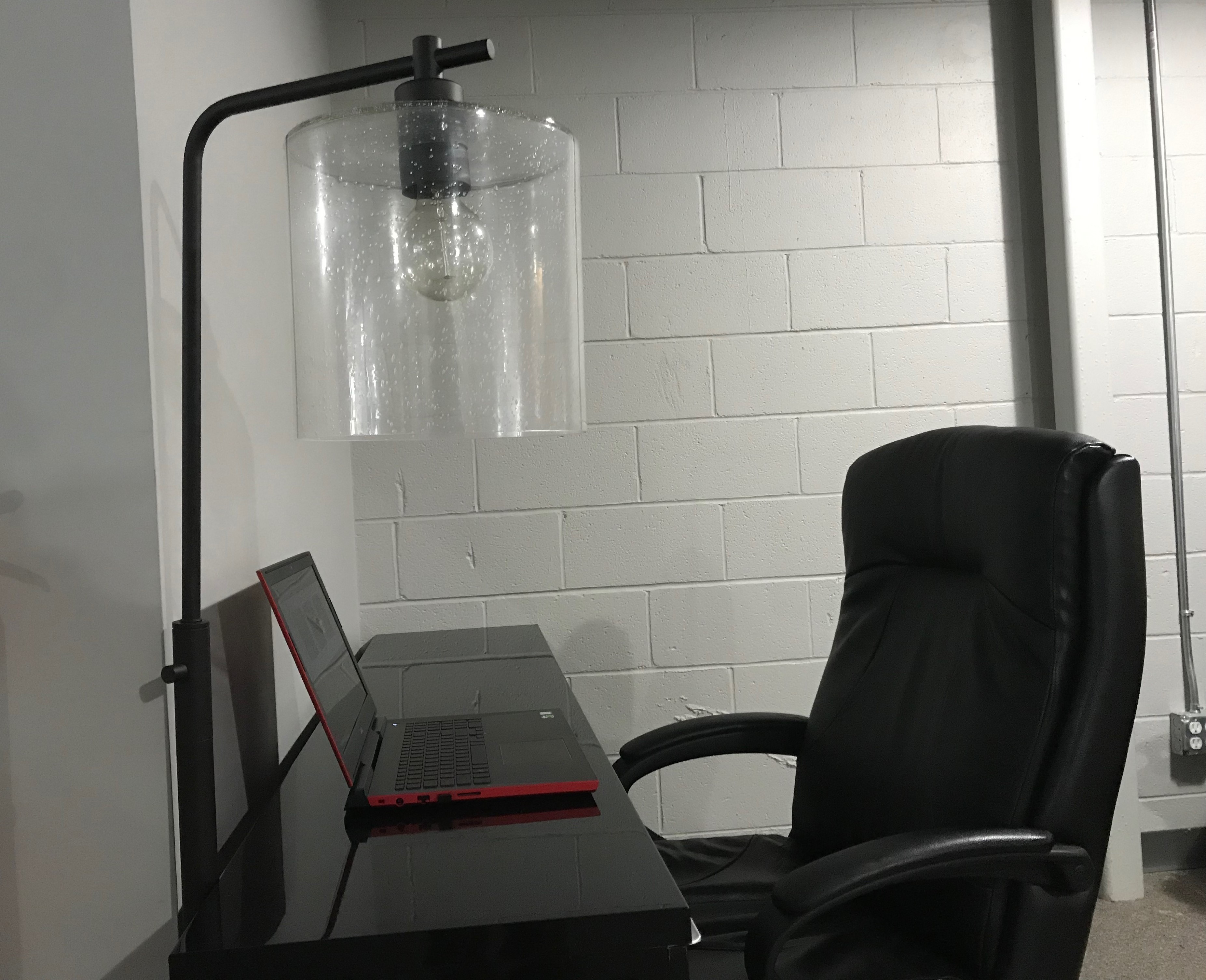 A black desk with a computer